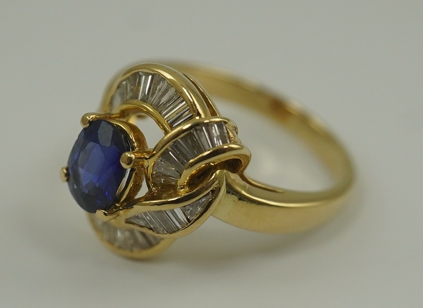 A modern 18k gold, sapphire and diamond cluster set dress ring